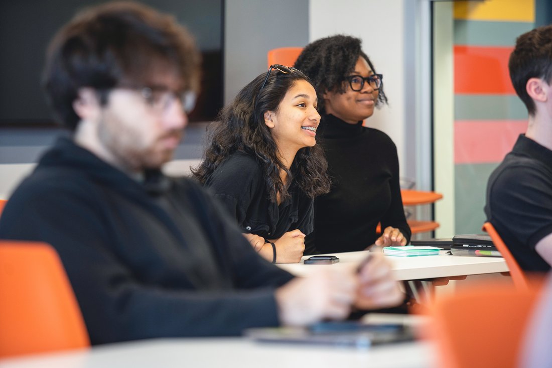 Students engaged in a classroom discussion at Syracuse University