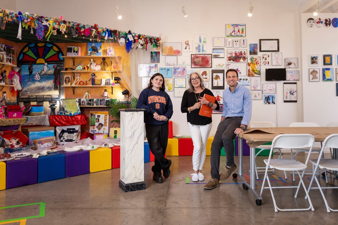 Three people standing inside La Casita.