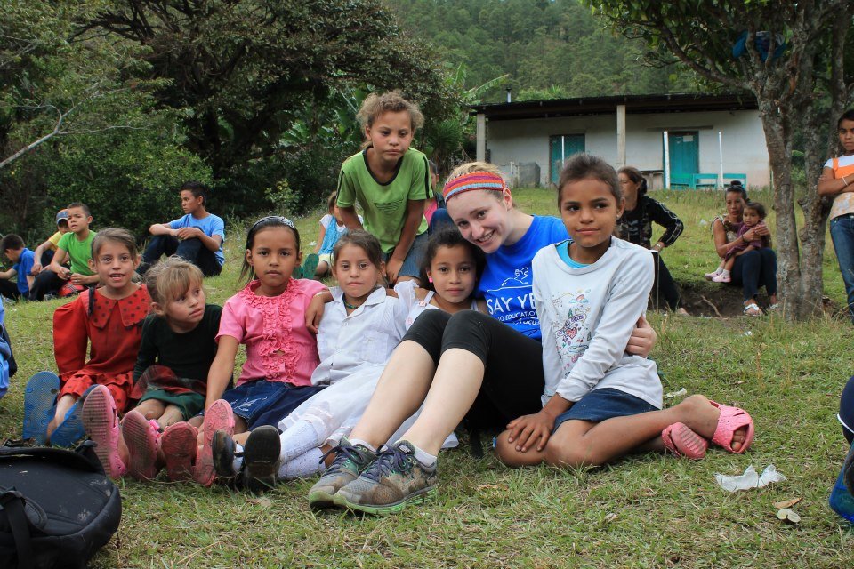 children sitting on a hill