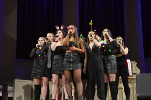 group of people singing on a stage