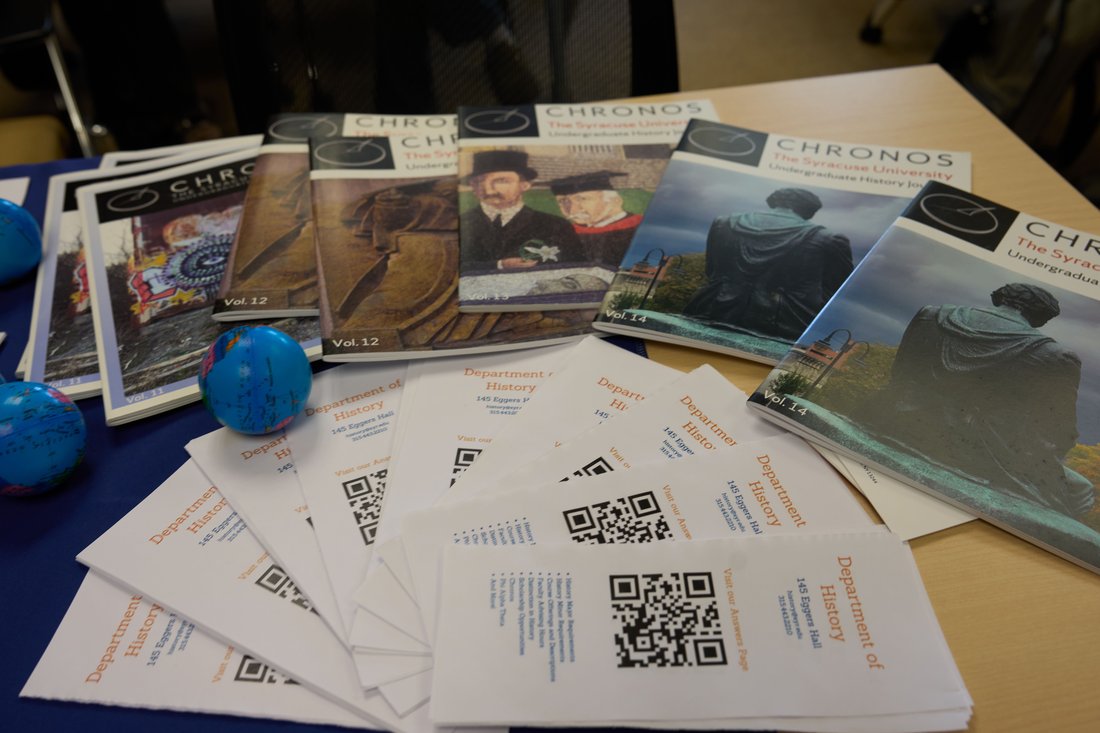 Copies of Chronos history journal issues displayed on a table with Department of History flyers.