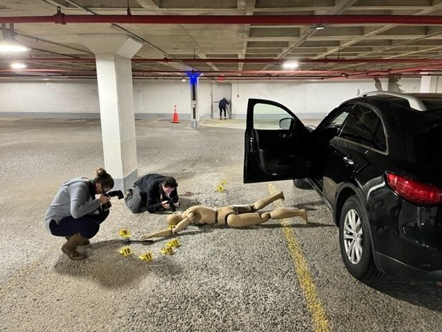 A person photographing evidence at a crime scene