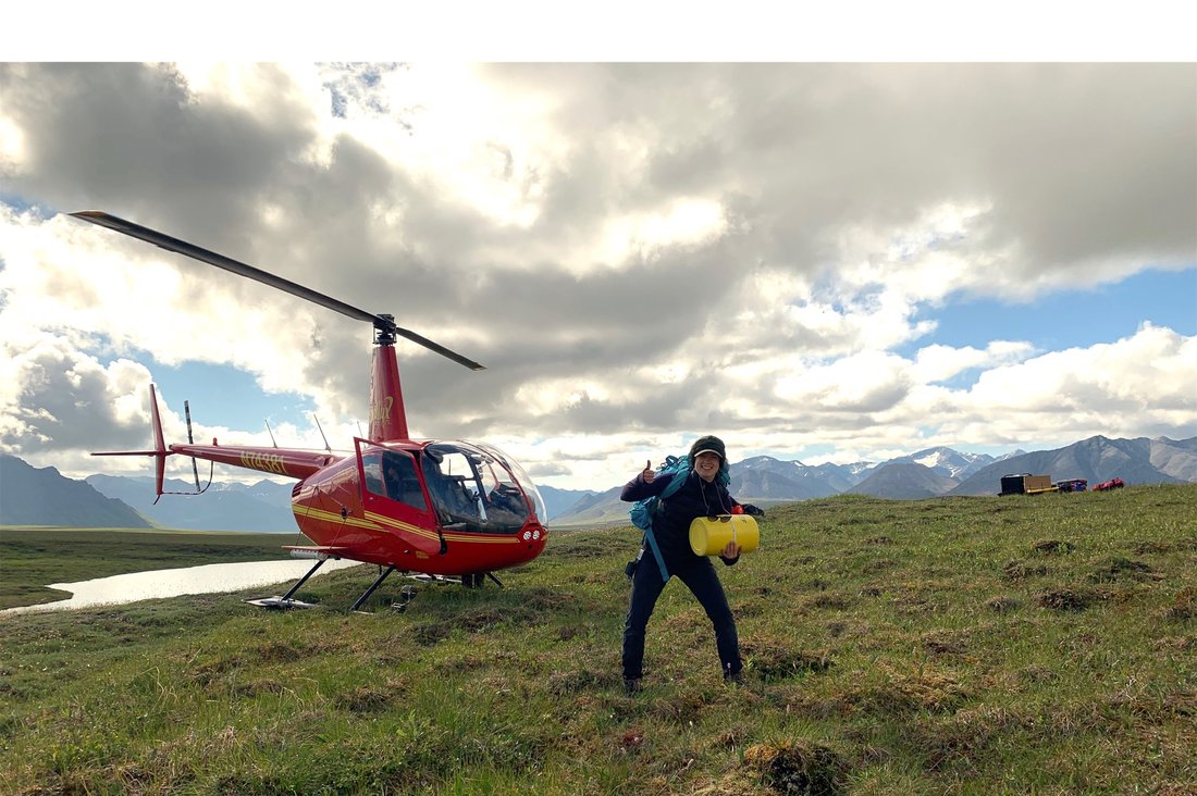 Person in front of a helicopter on a frozen field