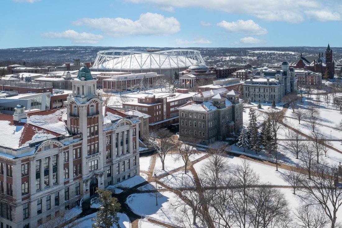 An aerial view of Syracuse University campus covered in snow.