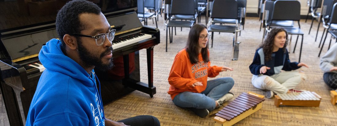 Students play instruments in a classroom