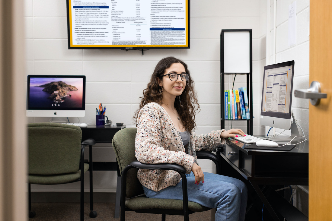 A woman sitting at a computer