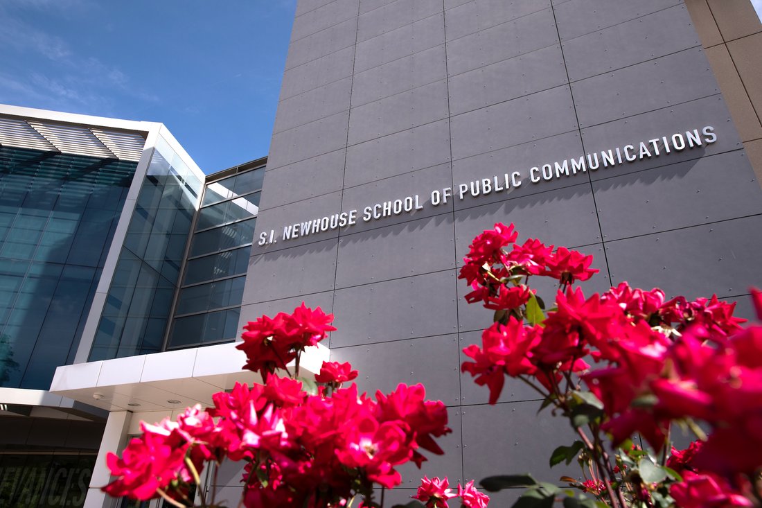 Entrance of Newhouse three with red flowers in the foreground