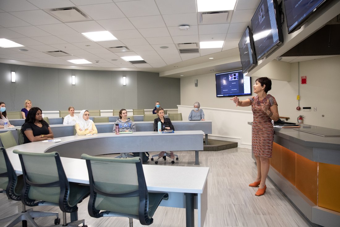 Students in a classroom listening to a guest lecture.