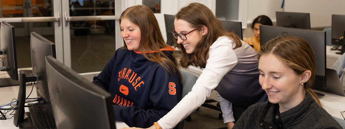 Sport analytics students work in a classroom together.