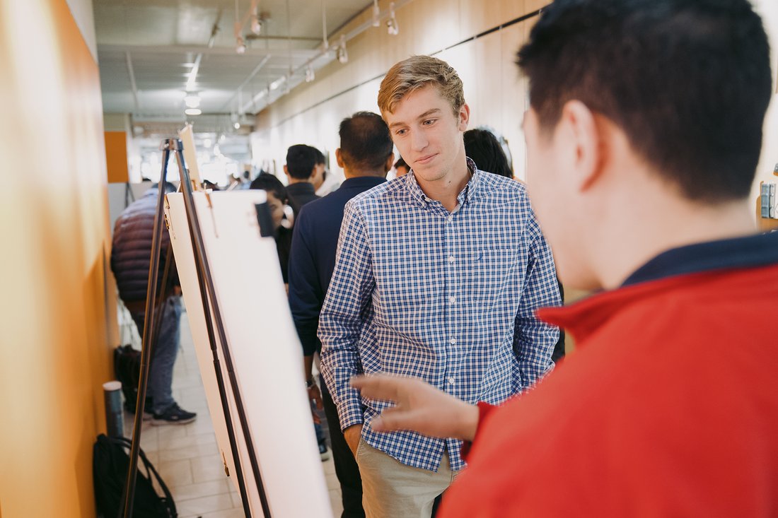 Student presents at a poster session.