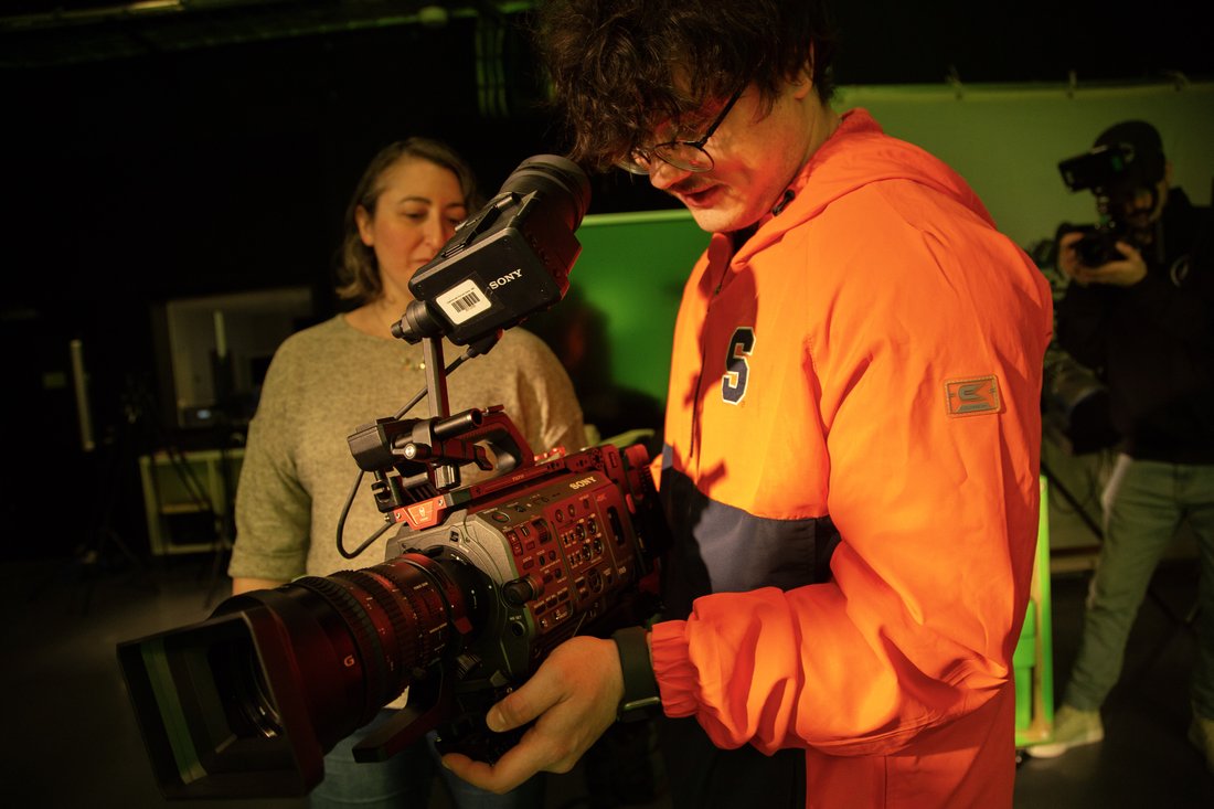 A TRF student operates a camera while professor Shaina Holmes assists