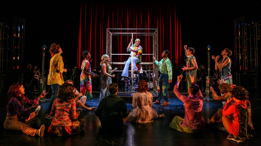 The cast of Sweet Charity performs a scene in costume on stage