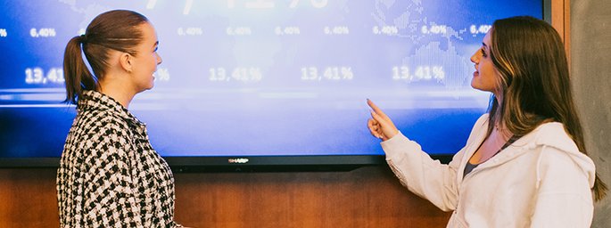 People presenting from a whiteboard.