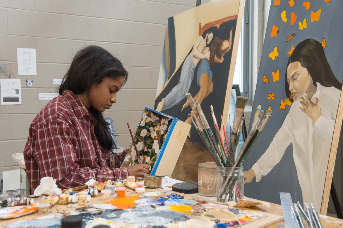 A person painting in an art studio