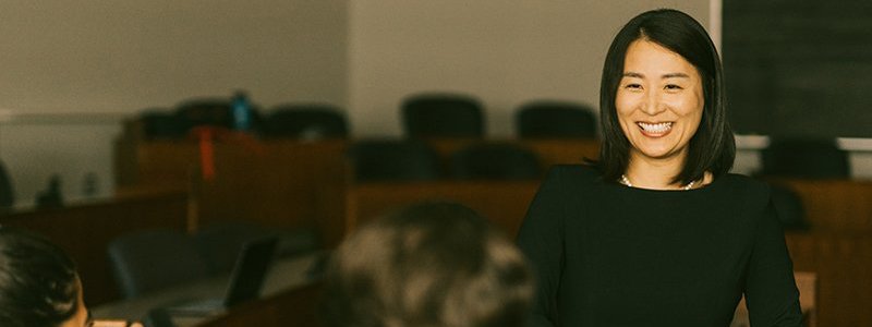 Professor smiling in a classroom.