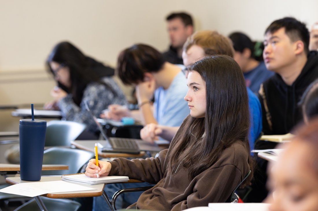 Student sitting and learning in class.