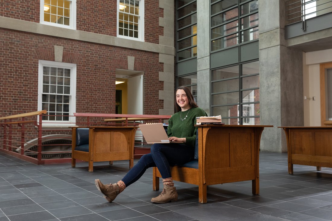 A person sitting with a laptop