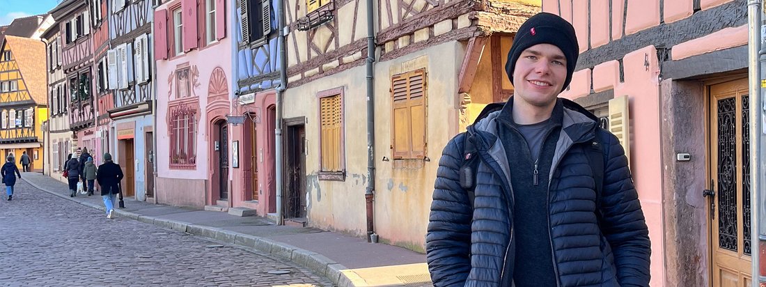 Study Abroad student standing in street in Strasbourg, France smiling.