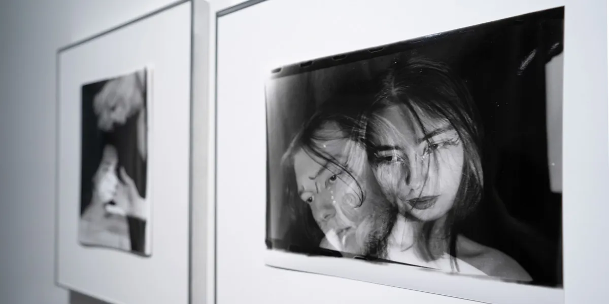 Framed black and white photograph of a man leaning against a woman.