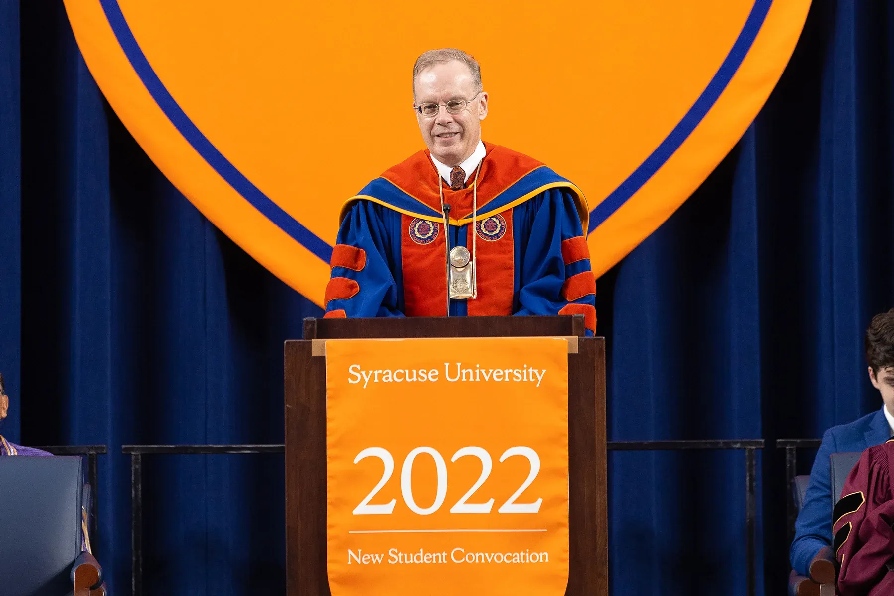 Chancellor Kent Syverud stands behind a podium speaking to the convocation crowd.