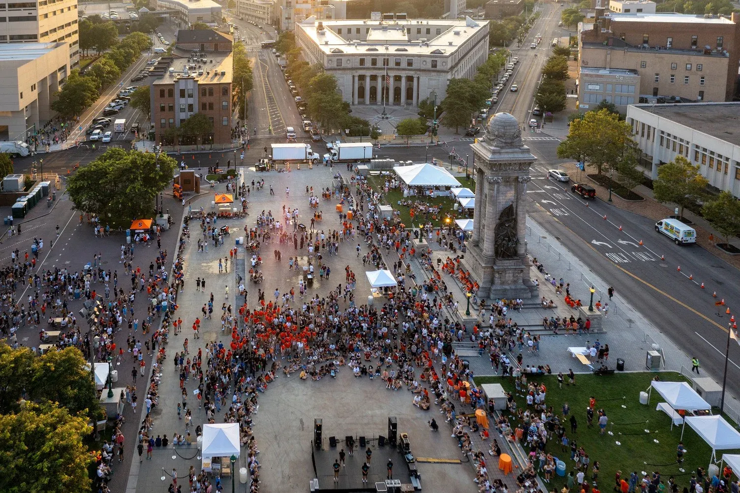 Aerial view of downtown Syracuse with large group of people in Clinton Square.