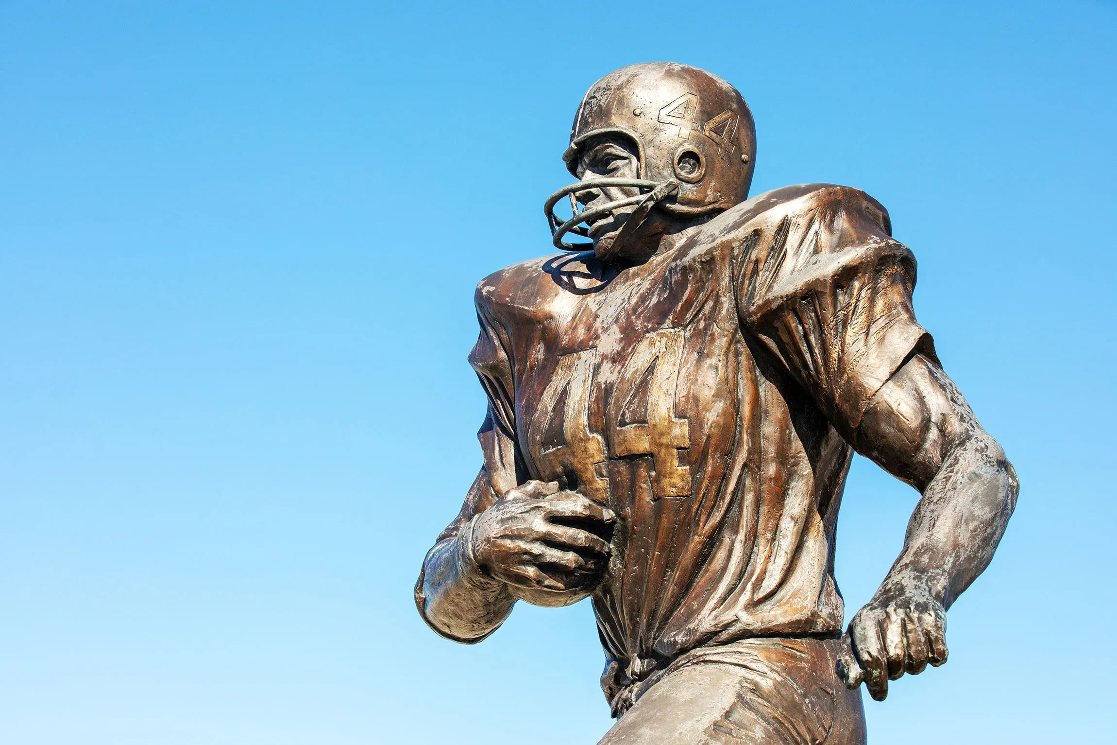 Statue of football player with number forty four jersey.